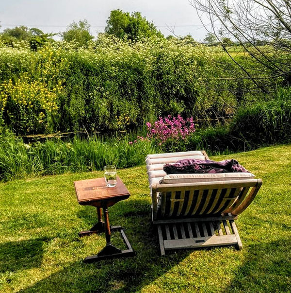 garden recliner by river 